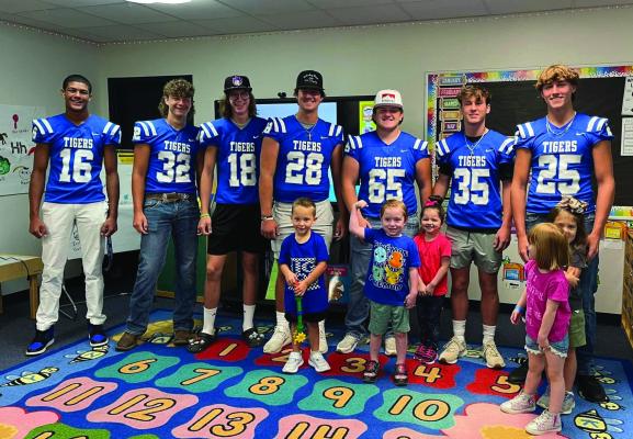 Athletes in Wills Point ISD are involved in the ‘Tiny Tiger’ program during the 2023-24 school year as they assist the other campuses’ students when they get out of the car as they arrive on campus each Friday morning. The ‘Tiny Tiger’ program also involves the older students visiting the classrooms of the younger children during the school day. Photo courtesy of Wills Point ISD Facebook page