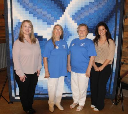 Among those in attendance May 7 during the Canton Texas Chamber of Commerce Quarterly Luncheon at The Silver Spur Resort were Cathy Anderson and Janet Cole with the Texas Star Quilters Guild as they displayed their ‘Blue Lily’ quilt. Standing with them were chamber Chief Executive Officer Kelli Ridgway, far left, and chamber board chairperson Ashley Knowles, far right. Photo by David Barber