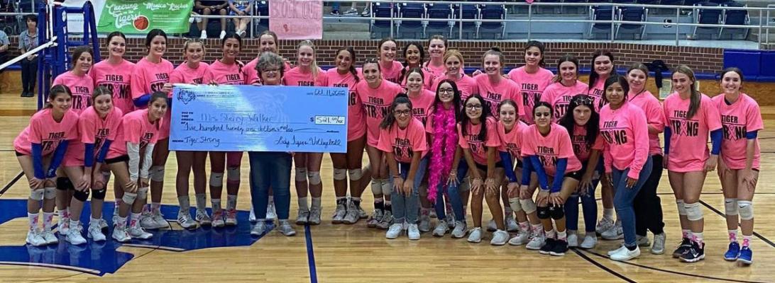 The Wills Point Lady Tiger volleyball program recognized longtime WPISD employee and breast cancer survivor Sherry Walker Oct. 11. In addition to honoring Walker, the team also raised more than $500 that were donated to the American Breast Cancer Foundation. Courtesy photo