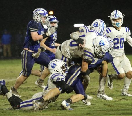 Players from Wills Point and Quinlan Ford battled each other and the elements during a rainy night at Hobart Lytal Memorial Stadium. Photo courtesy of WPHS Yearbook staff
